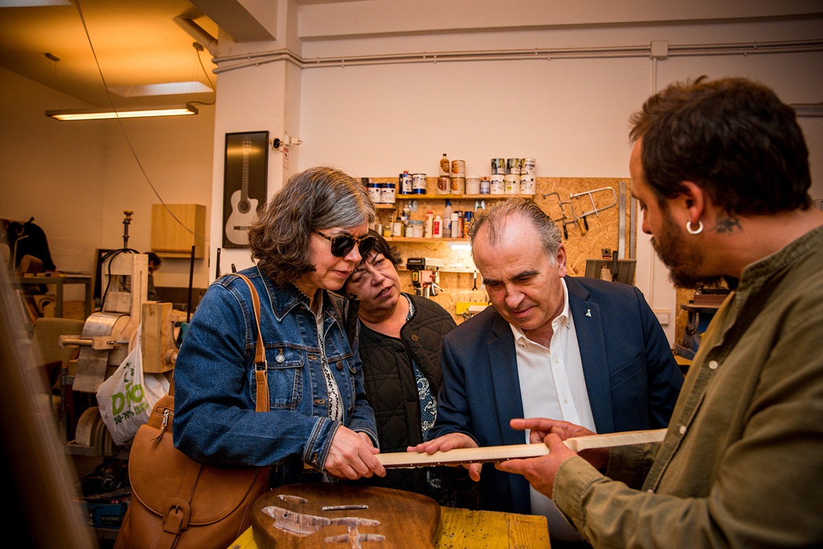 Fátima, Teresa y Luis Natalio tocan una de las piezas de madera de una guitarra